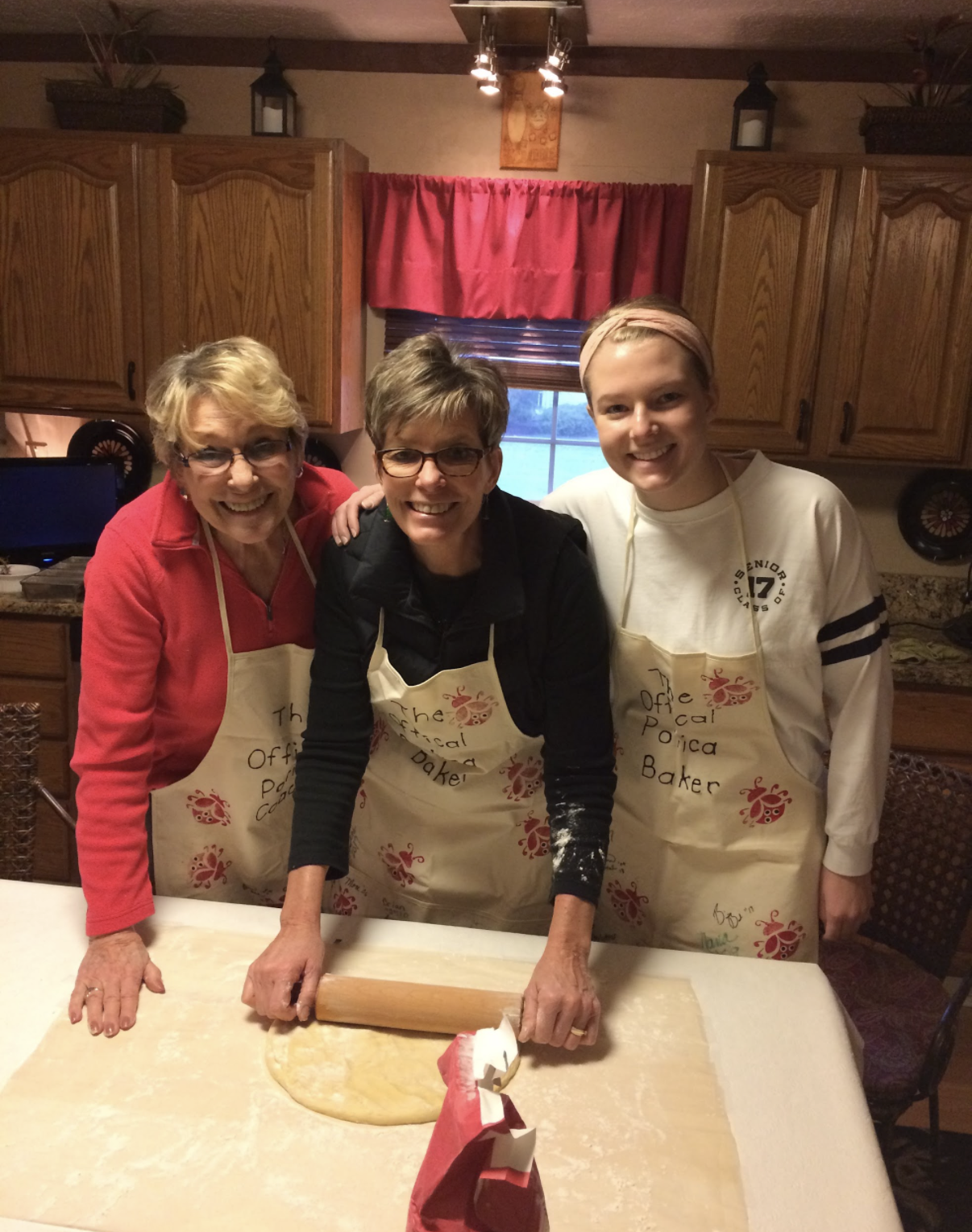 Three generations baking together in the kitchen with a rolling pin